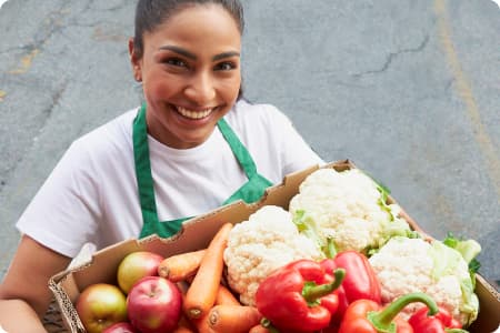 An Image of Girl with freshly produce fruits.